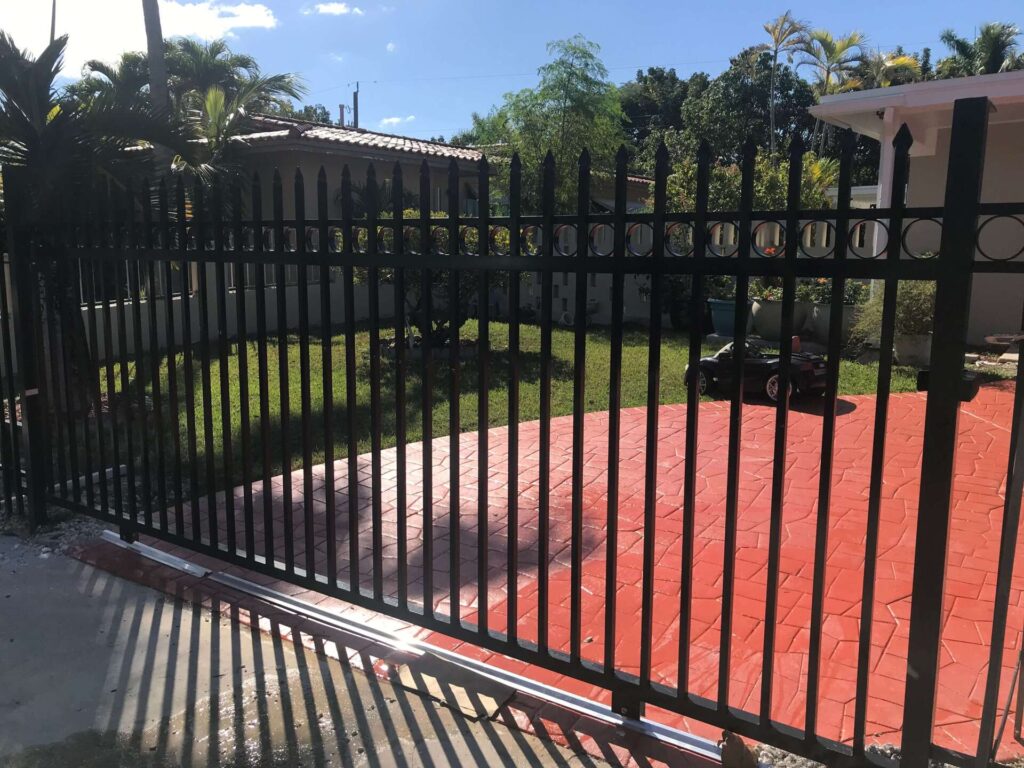 Black custom metal driveway gate installed by Griffiths Metal Products in South Florida