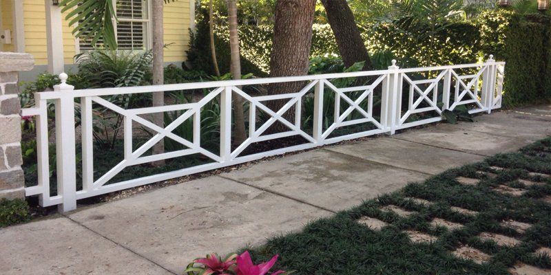 White decorative custom fence installed at a South Florida residence